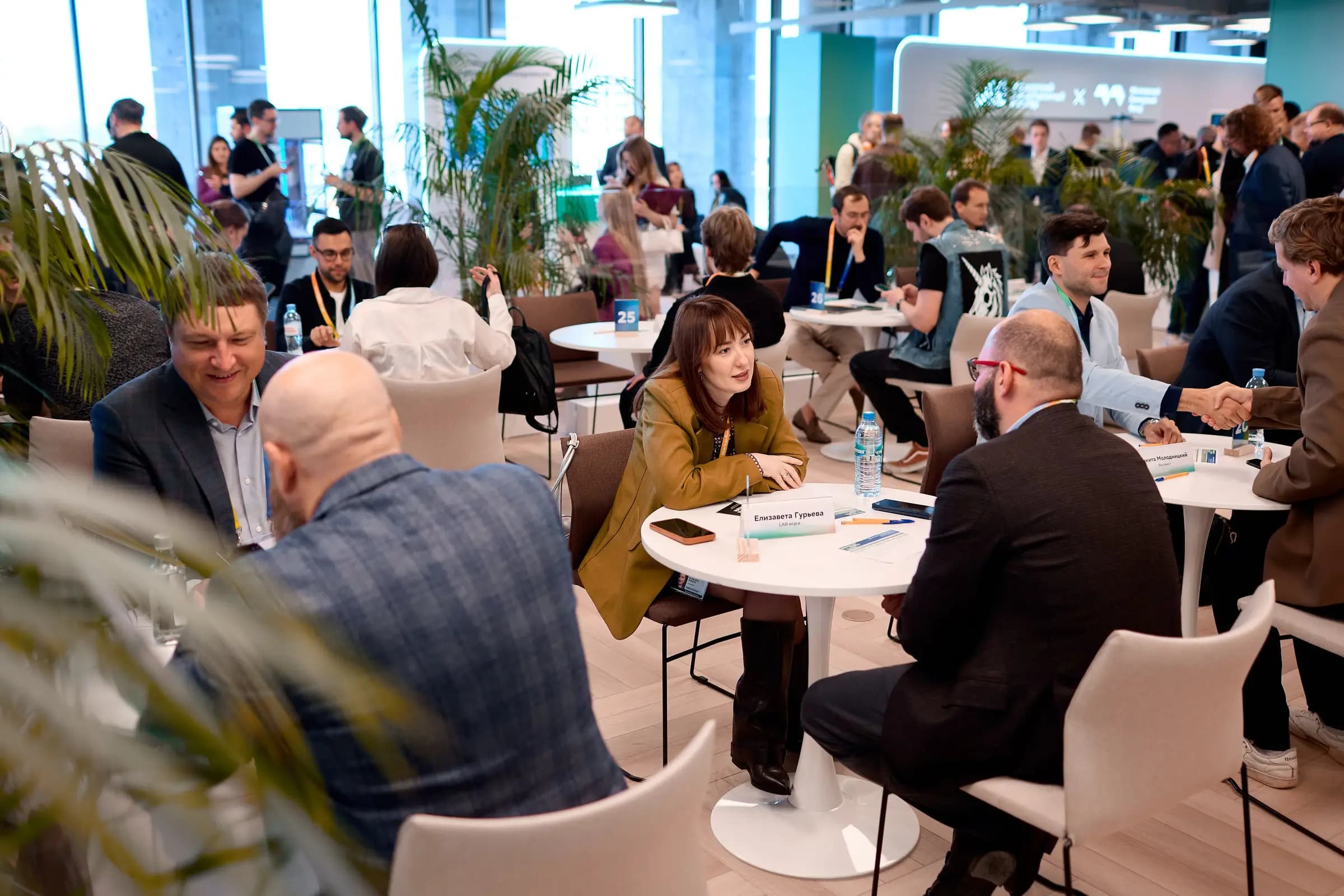 Moscow Startup Summit attendees talking at tables between sessions